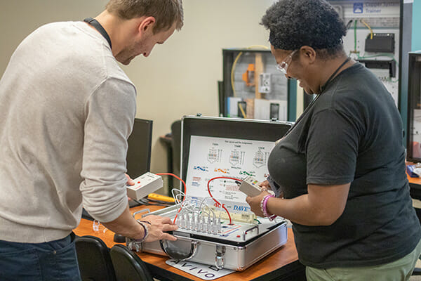 Student participates in hands-on telecommunications Installation and Support Training. Training is free (for students who meet eligibility requirements).