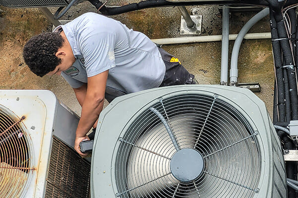 HVAC training through Avivo and the city of Minneapolis will lead to EPA's Section 608 refrigeration handling certification exam. In this photo a technician works on air conditioning.